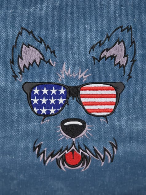 Detailed view of the Patriot Pup embroidery, showing the intricate red, white, and blue threadwork on a canvas background.